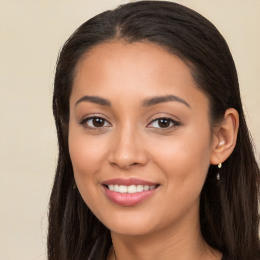 Joyful latino young-adult female with long  brown hair and brown eyes