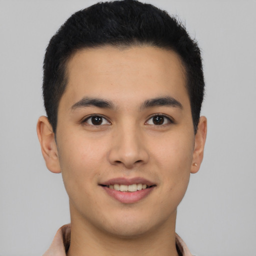 Joyful latino young-adult male with short  brown hair and brown eyes