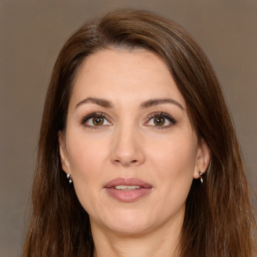 Joyful white young-adult female with long  brown hair and brown eyes