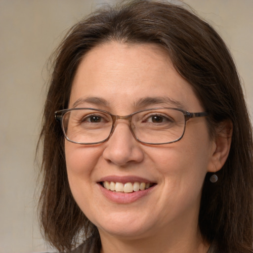 Joyful white adult female with medium  brown hair and brown eyes