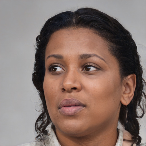 Neutral black young-adult female with medium  brown hair and brown eyes
