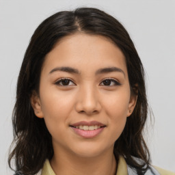 Joyful latino young-adult female with medium  brown hair and brown eyes