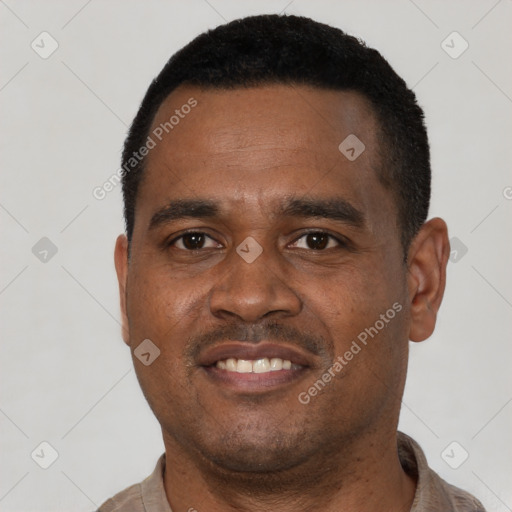 Joyful latino young-adult male with short  black hair and brown eyes