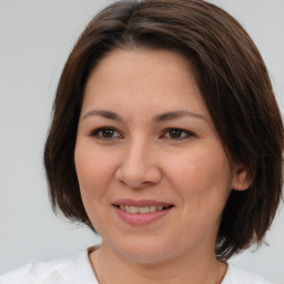 Joyful white adult female with medium  brown hair and brown eyes