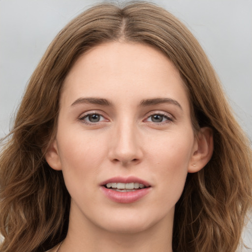 Joyful white young-adult female with long  brown hair and grey eyes