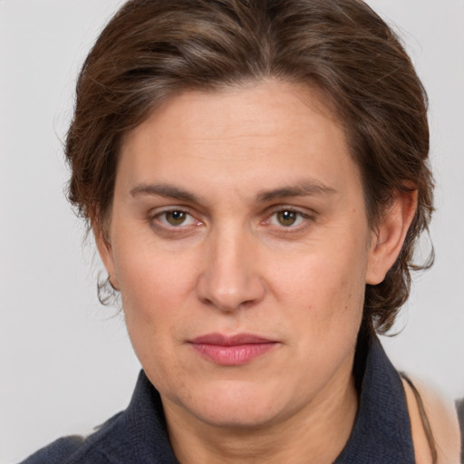 Joyful white adult female with medium  brown hair and grey eyes