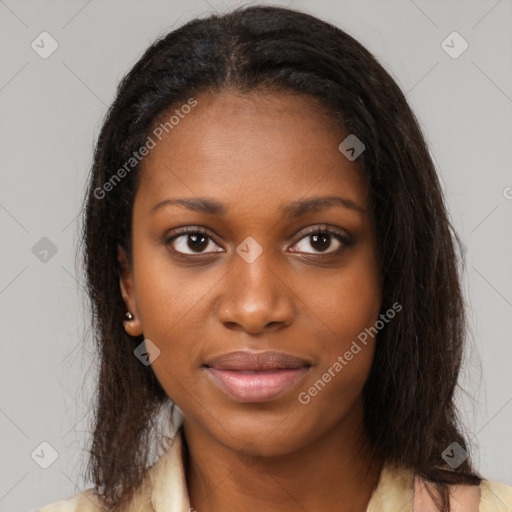 Joyful black young-adult female with long  brown hair and brown eyes