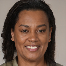 Joyful latino adult female with medium  brown hair and brown eyes