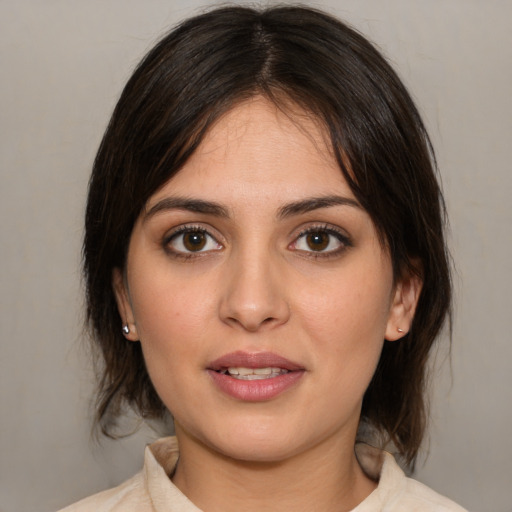 Joyful white young-adult female with medium  brown hair and brown eyes