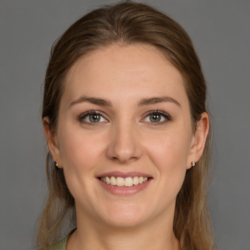 Joyful white young-adult female with long  brown hair and grey eyes