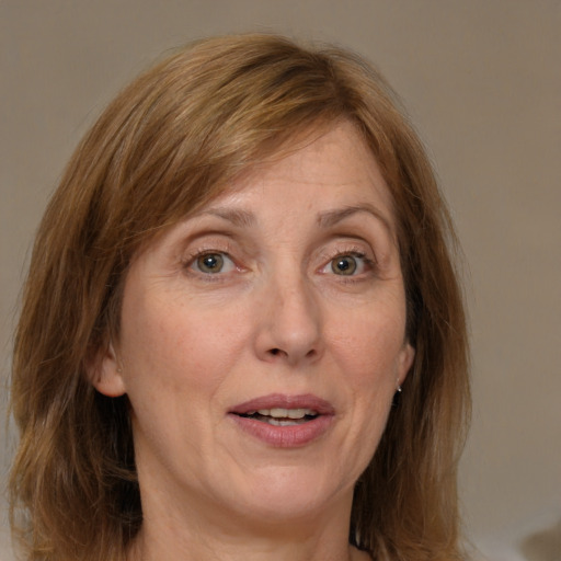 Joyful white adult female with medium  brown hair and grey eyes