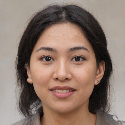 Joyful asian young-adult female with medium  brown hair and brown eyes