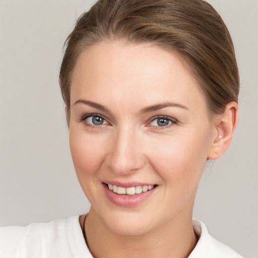 Joyful white young-adult female with short  brown hair and grey eyes