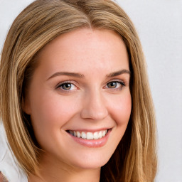 Joyful white young-adult female with long  brown hair and blue eyes