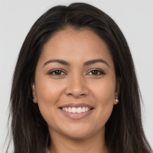 Joyful latino young-adult female with long  brown hair and brown eyes