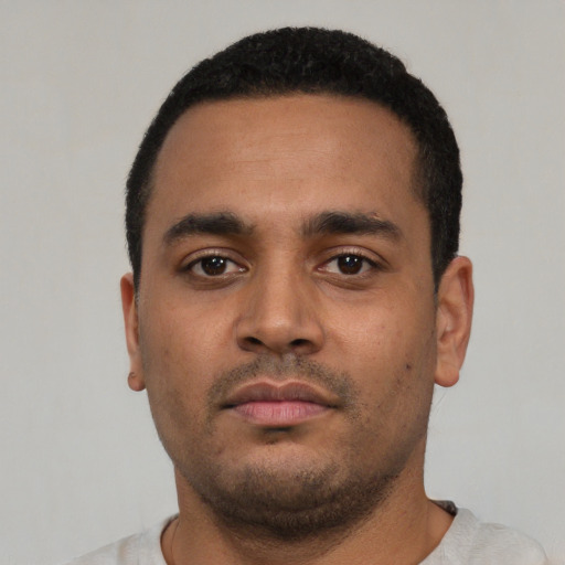 Neutral latino young-adult male with short  black hair and brown eyes