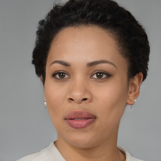 Joyful black young-adult female with short  brown hair and brown eyes