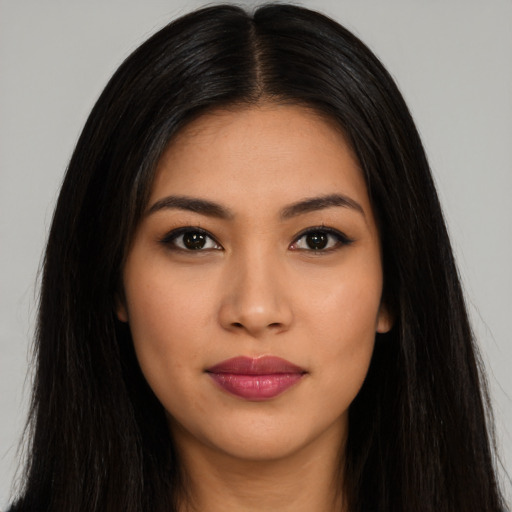 Joyful latino young-adult female with long  black hair and brown eyes