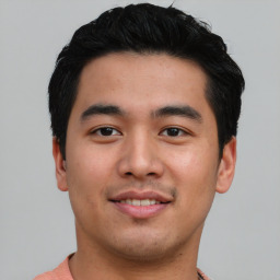 Joyful asian young-adult male with short  black hair and brown eyes