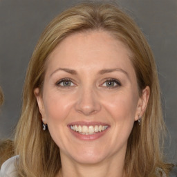 Joyful white adult female with long  brown hair and brown eyes