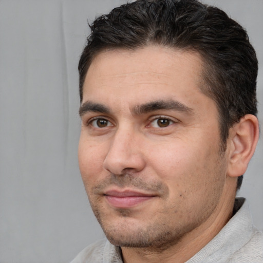 Joyful white adult male with short  brown hair and brown eyes