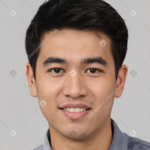 Joyful asian young-adult male with short  black hair and brown eyes