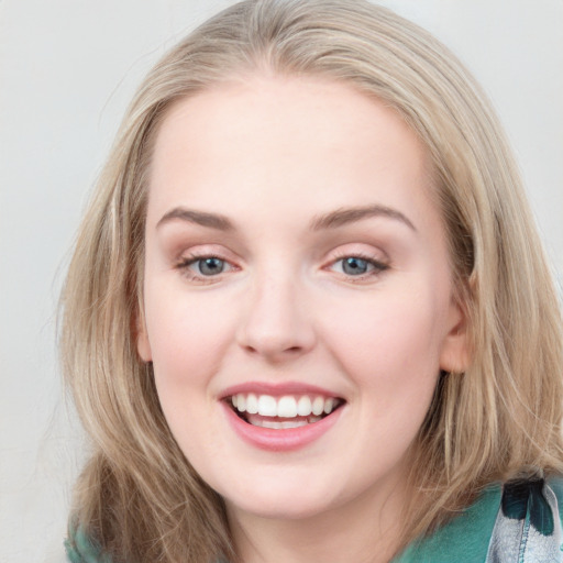 Joyful white young-adult female with medium  brown hair and blue eyes