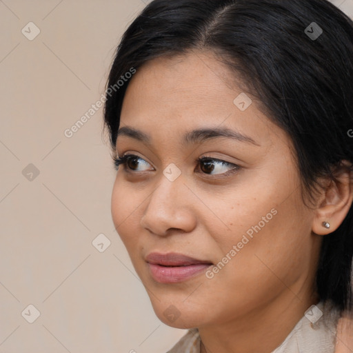 Joyful latino young-adult female with medium  brown hair and brown eyes