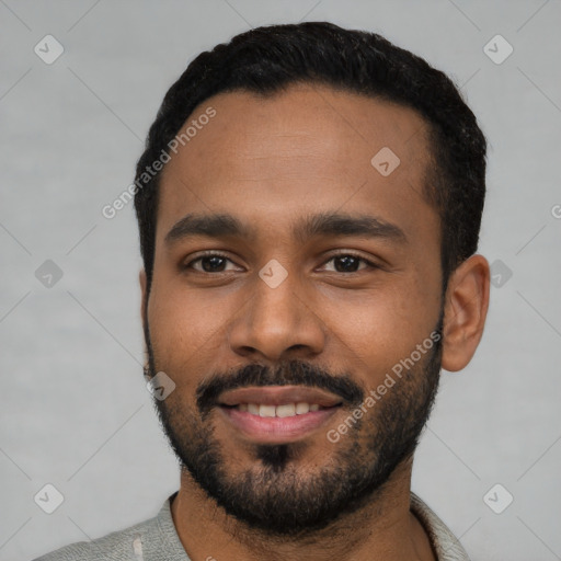 Joyful black young-adult male with short  black hair and brown eyes