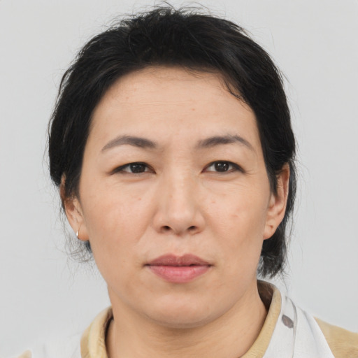 Neutral asian adult female with medium  brown hair and brown eyes