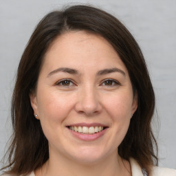 Joyful white young-adult female with medium  brown hair and brown eyes