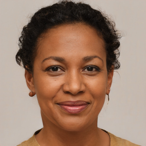 Joyful black adult female with short  brown hair and brown eyes