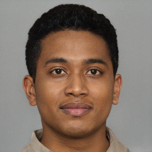 Joyful black young-adult male with short  black hair and brown eyes
