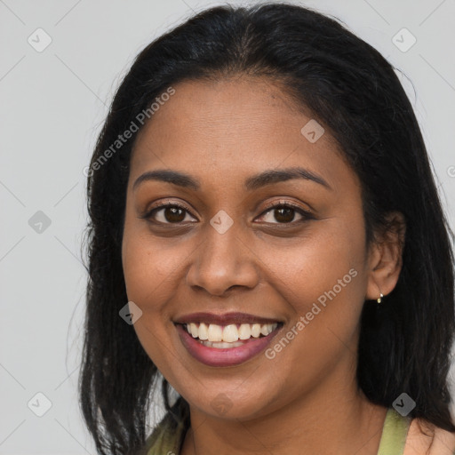 Joyful black young-adult female with long  brown hair and brown eyes