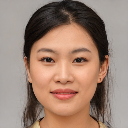 Joyful asian young-adult female with medium  brown hair and brown eyes