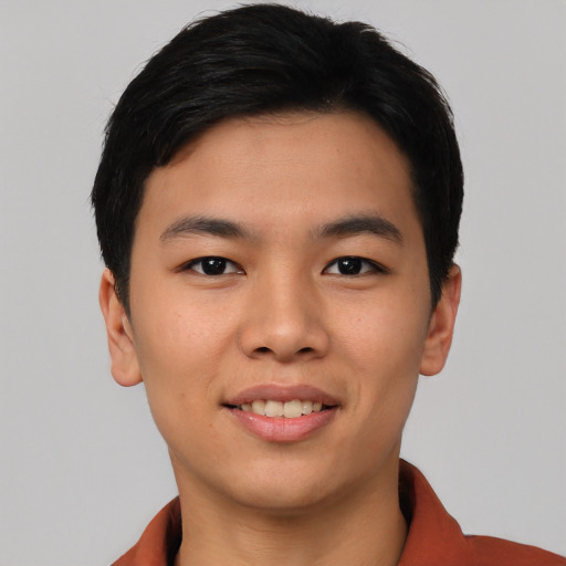 Joyful asian young-adult male with short  black hair and brown eyes