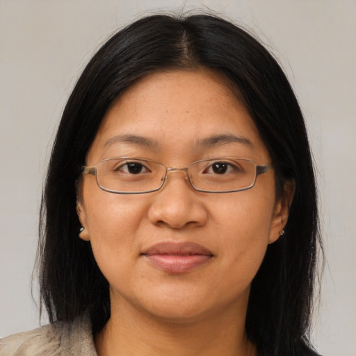 Joyful asian adult female with long  brown hair and brown eyes