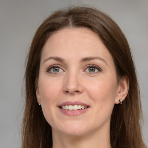 Joyful white young-adult female with long  brown hair and grey eyes