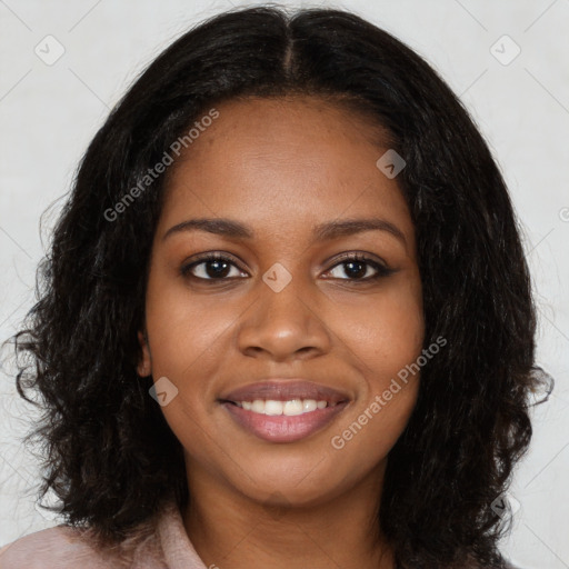 Joyful black young-adult female with long  black hair and brown eyes