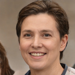 Joyful white adult female with medium  brown hair and brown eyes