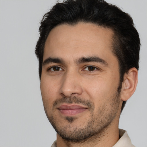 Joyful white young-adult male with short  black hair and brown eyes