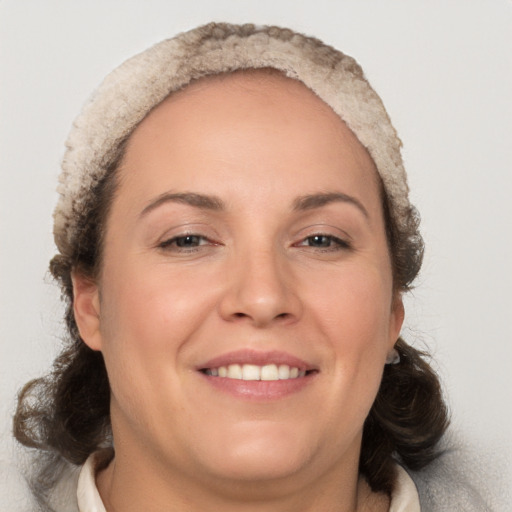 Joyful white adult female with medium  brown hair and brown eyes