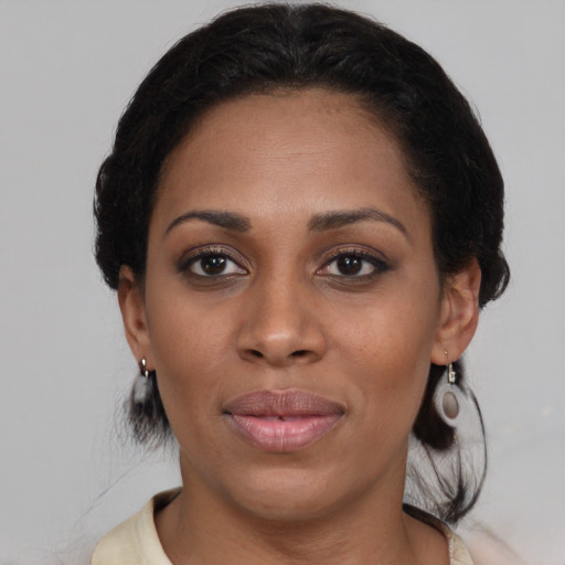 Joyful black young-adult female with medium  brown hair and brown eyes