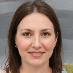 Joyful white adult female with medium  brown hair and brown eyes