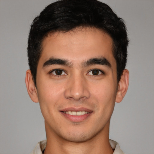 Joyful latino young-adult male with short  brown hair and brown eyes