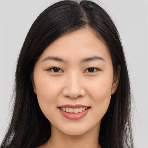 Joyful asian young-adult female with long  brown hair and brown eyes