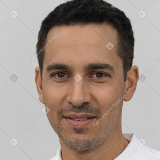 Joyful white young-adult male with short  black hair and brown eyes