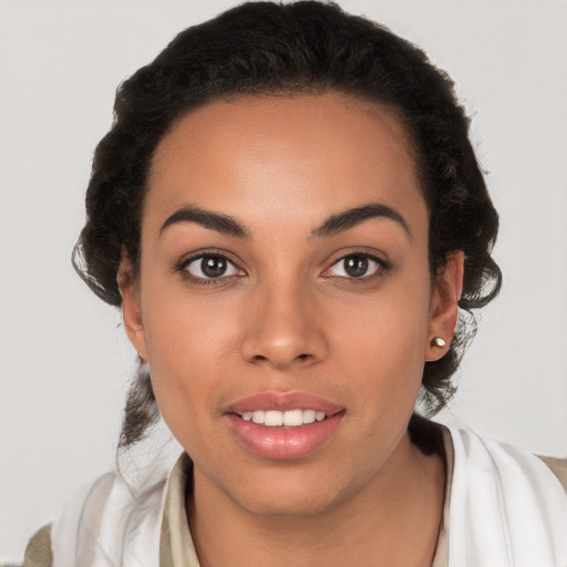 Joyful latino young-adult female with long  brown hair and brown eyes