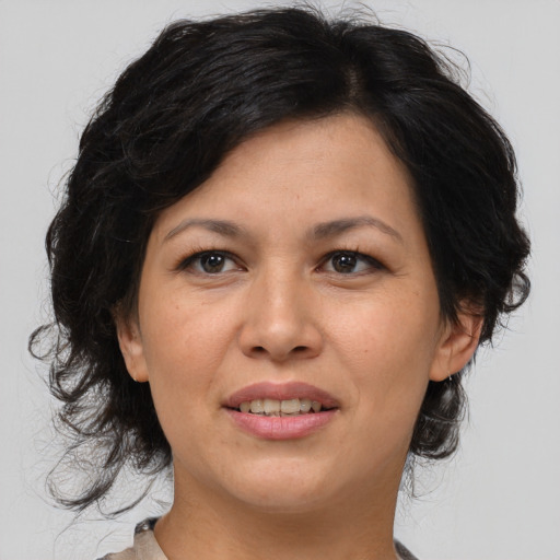 Joyful asian adult female with medium  brown hair and brown eyes