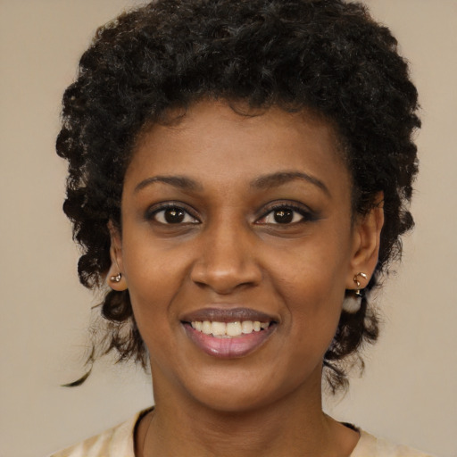 Joyful black young-adult female with medium  black hair and brown eyes